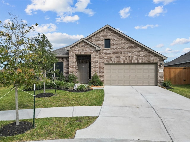 view of front of home with a garage and a front lawn