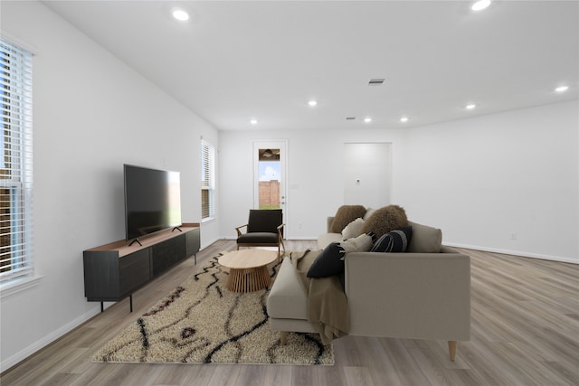 living room featuring light wood-style floors, a wealth of natural light, and recessed lighting