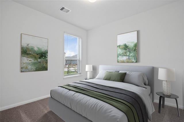 carpeted bedroom with visible vents and baseboards