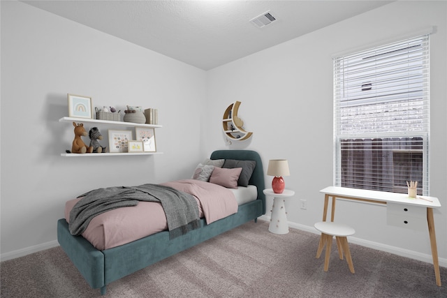 bedroom featuring baseboards, visible vents, and carpet flooring