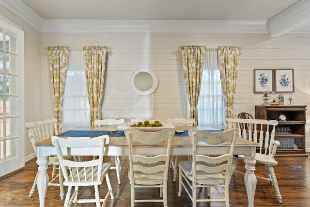 dining area featuring crown molding, wood walls, and dark hardwood / wood-style floors