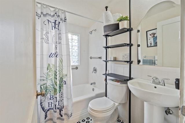 bathroom with tasteful backsplash, shower / bath combo with shower curtain, tile walls, and toilet