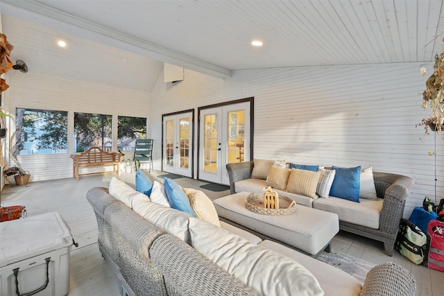 living room with high vaulted ceiling, wooden ceiling, beamed ceiling, light hardwood / wood-style floors, and wood walls