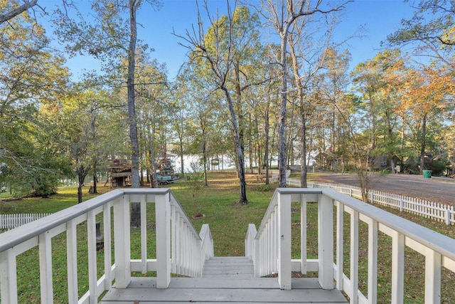 wooden deck featuring a lawn