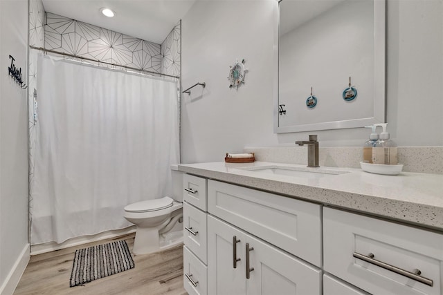 full bathroom with shower / bathtub combination with curtain, vanity, wood-type flooring, and toilet