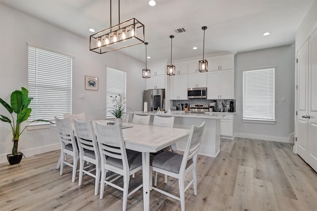 dining space with light wood-type flooring