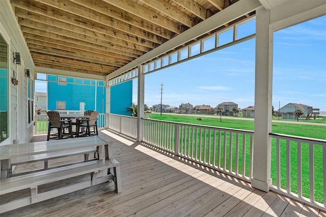 wooden deck with a lawn