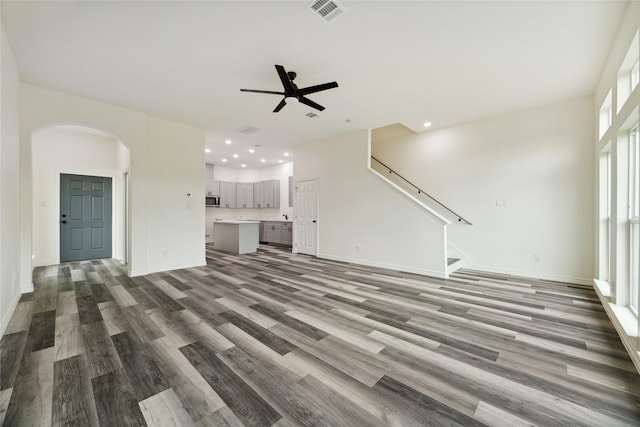 unfurnished living room featuring hardwood / wood-style floors and ceiling fan