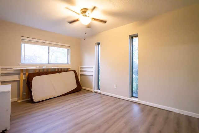 unfurnished bedroom featuring ceiling fan and light wood-type flooring