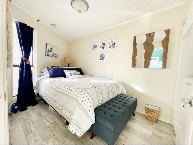 bedroom with multiple windows, crown molding, and light wood-type flooring