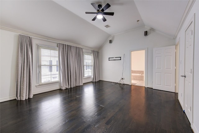 empty room with ceiling fan, dark hardwood / wood-style flooring, ornamental molding, and vaulted ceiling