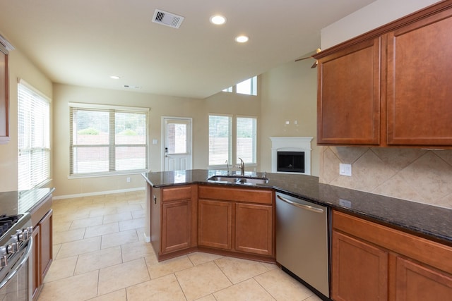 kitchen with tasteful backsplash, a wealth of natural light, sink, and appliances with stainless steel finishes