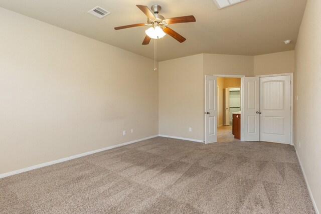 carpeted spare room with ceiling fan