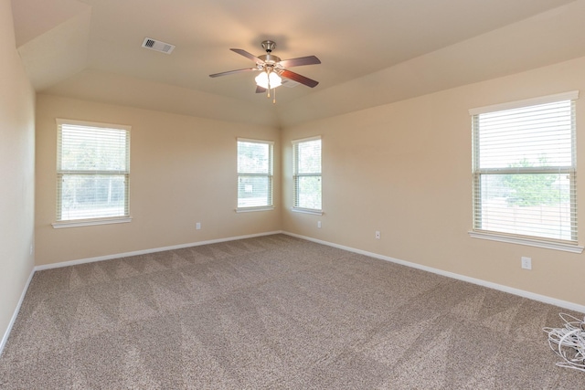 spare room featuring ceiling fan, carpet floors, and a wealth of natural light