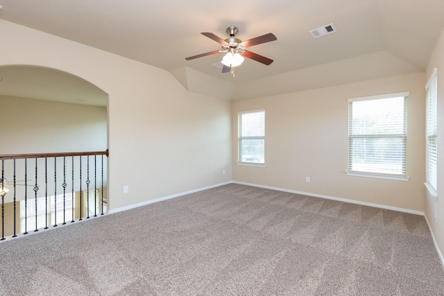 spare room with carpet floors, vaulted ceiling, and ceiling fan