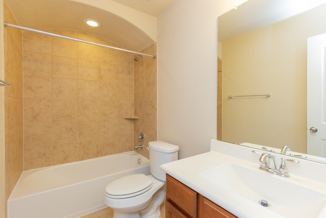 full bathroom with vanity, tiled shower / bath combo, and toilet