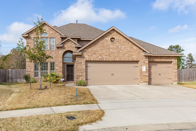 view of front of house featuring a front lawn and a garage