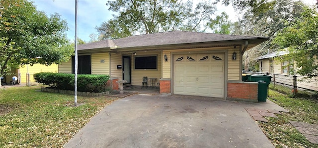 single story home featuring a front yard and a garage