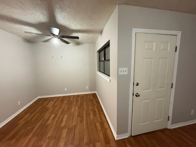 unfurnished room with wood-type flooring, a textured ceiling, and ceiling fan