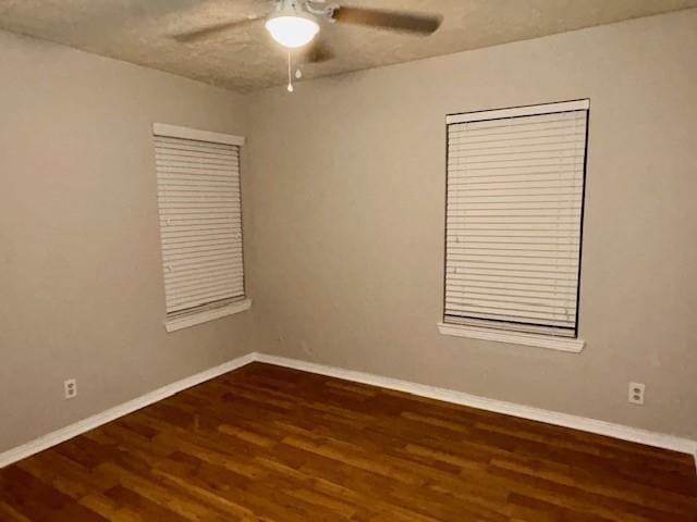 unfurnished room featuring ceiling fan and dark hardwood / wood-style floors