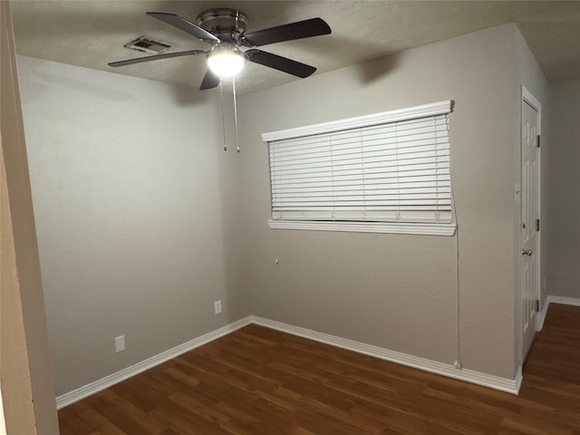 spare room featuring ceiling fan and dark hardwood / wood-style flooring