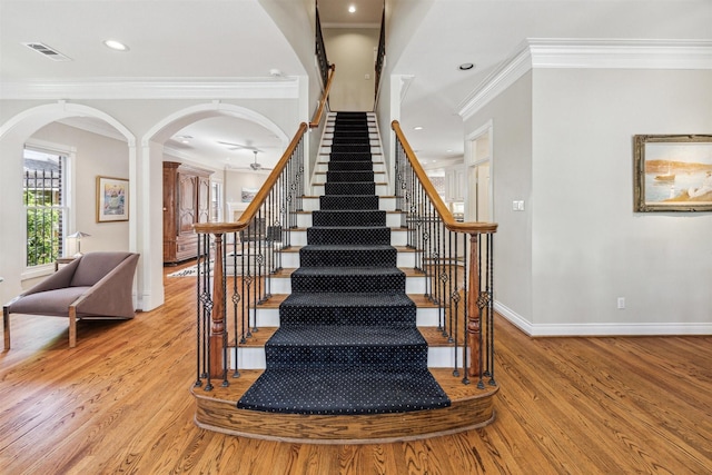 stairway featuring hardwood / wood-style flooring and ornamental molding