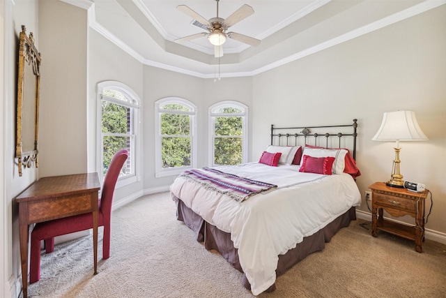 bedroom featuring a raised ceiling, ceiling fan, light colored carpet, and ornamental molding