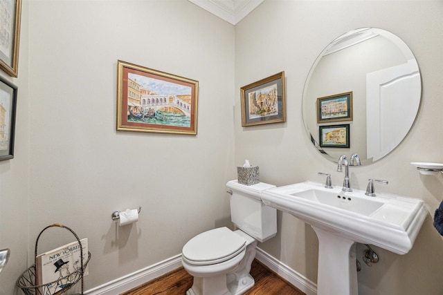 bathroom featuring sink, toilet, wood-type flooring, and crown molding