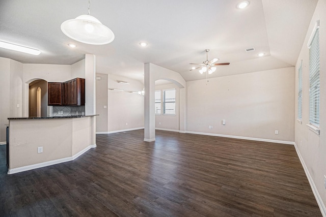 unfurnished living room featuring ceiling fan, lofted ceiling, and dark wood-type flooring