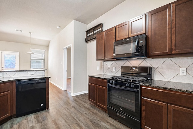 kitchen with tasteful backsplash, dark brown cabinetry, black appliances, wood-type flooring, and pendant lighting