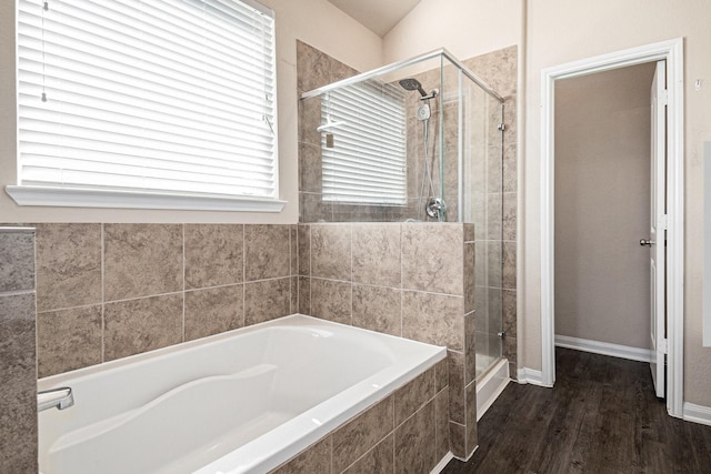 bathroom featuring lofted ceiling, wood-type flooring, and independent shower and bath