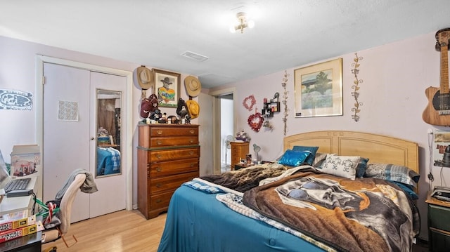 bedroom featuring light hardwood / wood-style flooring and a closet