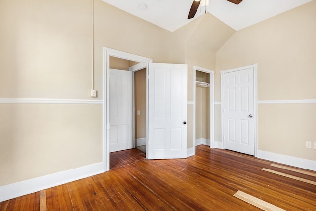 unfurnished bedroom with ceiling fan, dark wood-type flooring, and vaulted ceiling