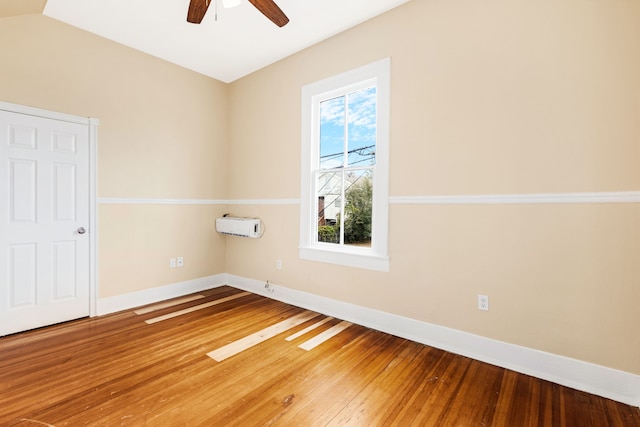 spare room featuring ceiling fan, plenty of natural light, and hardwood / wood-style floors