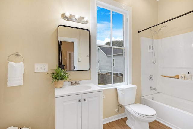 full bathroom featuring vanity, toilet, wood-type flooring, and washtub / shower combination