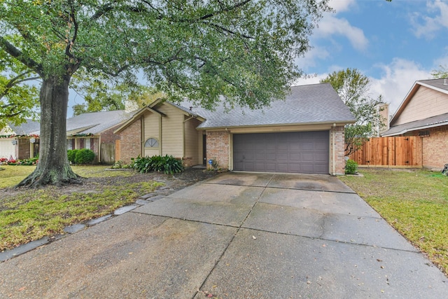 single story home featuring a front lawn and a garage