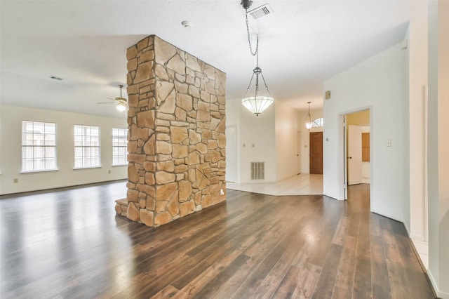 unfurnished living room with ceiling fan and hardwood / wood-style floors