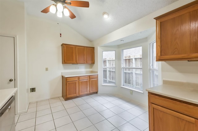 10306 Wayward Wind Ln, Houston, TX 77064 - kitchen featuring lofted ceiling, light countertops, ceiling fan, and brown cabinets