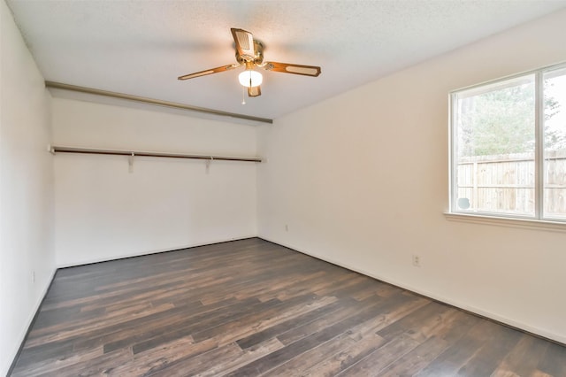 10306 Wayward Wind Ln, Houston, TX 77064 - unfurnished bedroom featuring dark wood-style floors, ceiling fan, a closet, and a textured ceiling