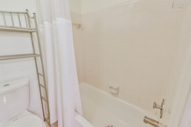 bathroom featuring shower / bath combo and toilet