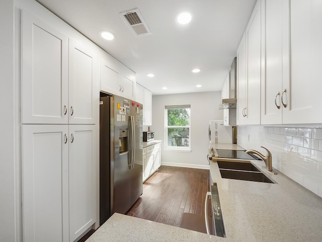 kitchen featuring appliances with stainless steel finishes, dark hardwood / wood-style floors, white cabinetry, and sink