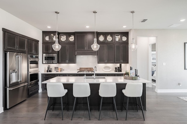 kitchen featuring pendant lighting, sink, dark hardwood / wood-style flooring, and stainless steel appliances