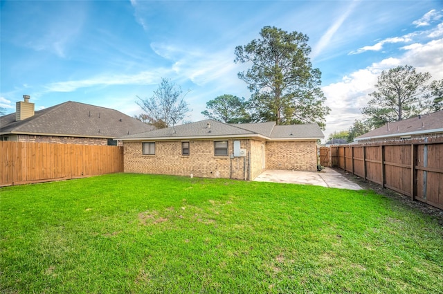 back of property featuring a yard and a patio