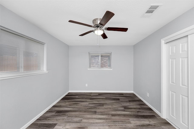 unfurnished room featuring ceiling fan and dark hardwood / wood-style flooring