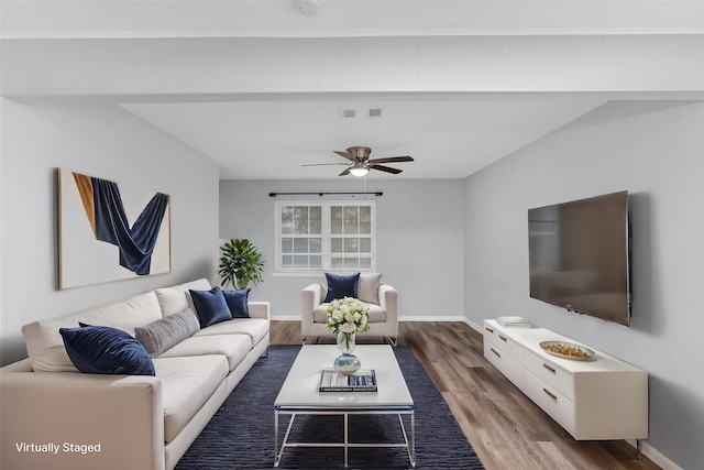 living room with ceiling fan and dark hardwood / wood-style floors