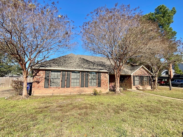 ranch-style home with a front lawn