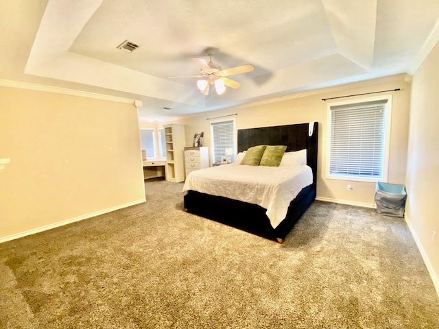 bedroom featuring carpet floors, a tray ceiling, ceiling fan, and ornamental molding