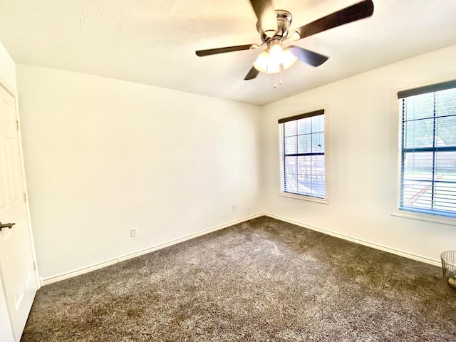 carpeted spare room featuring ceiling fan