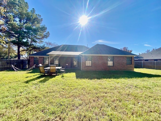 back of property featuring a lawn