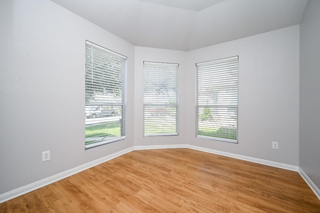 unfurnished room featuring light wood finished floors and baseboards